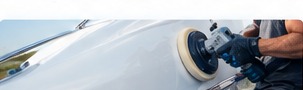 Technician buffing gelcoat on a boat hull